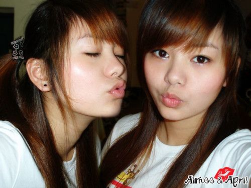Asian twins kiss