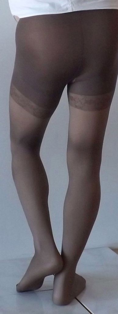 Face between her pantyhose thighs