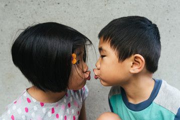Asian twins kiss