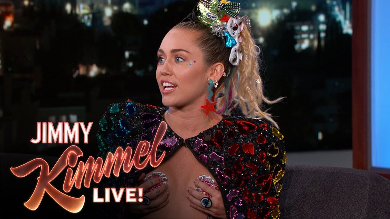 Miley cyrus flashes a boob photo